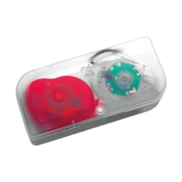 Kaksi led-pyörävaloa läpinäkyvässä muovikotelossa, toinen punainen ja toinen valkoinen.