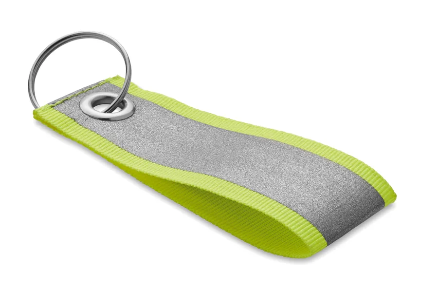 Heijastava avaimenperä, jossa harmaa heijastava pinta, neonkeltaiset reunat ja metallirengas.