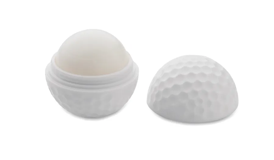 Valkoinen golfpallon muotoinen huulirasvakotelo avattuna ja kansi vieressä.