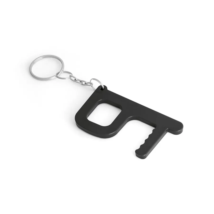 Musta monitoiminen avaimenperä, jossa suorakaiteen muotoinen aukko, hammastettu kärki ja metallinen rengas.
