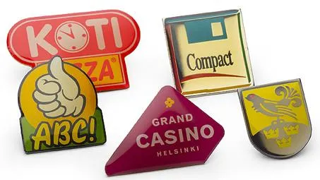 Various shaped offset-printed pins with customer logos and text in different colours.